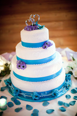 Colorful blue and purple wedding cake with silver wedding topper