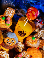 Halloween table with trick or treat food. Carving Halloween Jack OLanten pumpkin. Top view.