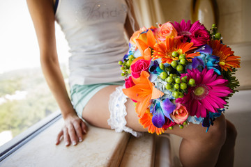 Bride with colorful bouquet taking a break before getting in her