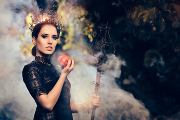 Evil Queen with Poisoned  Apple in Misty Forest