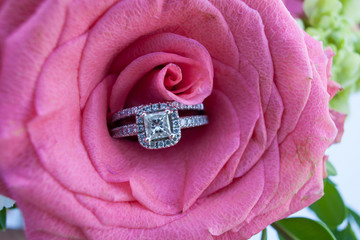 Wedding rings in a pink rose