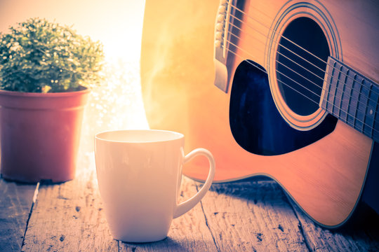 Coffee Cup And Acoustic Guitar Next The Window With Drop Water