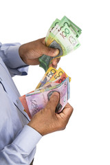 Man checking or counting Australian dollars in hand.