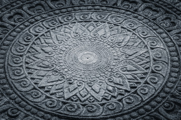 dark stone carving in Thai art pattern for background.