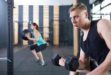 functional fitness workout with dumbbell at the gym