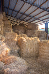 Hay stacks and bales at farm haylof