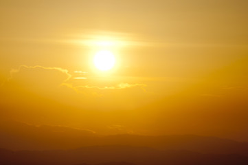sunset on mountain, subject is blurred and low key