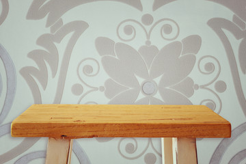 Empty small table in front of retro background