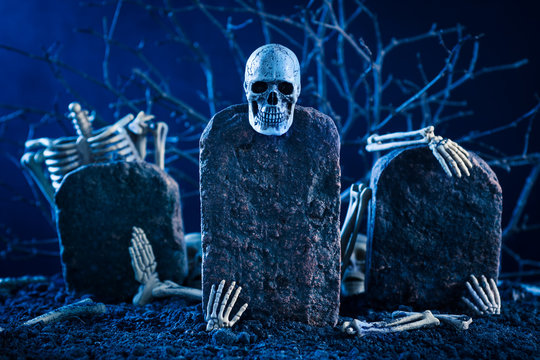 Skeleton Are Scatter On The Tombstone In The Night Time Graveyard