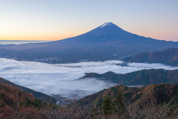 Mountain Fuji and sea of mist above Kawaguchiko lake in morning autumn season