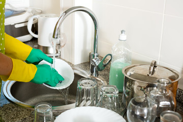 View on hands in protective rubber gloves