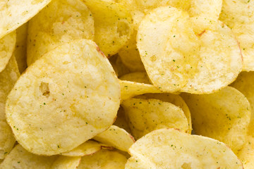 Close up potato chips on top view background.
