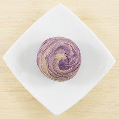 The Taiwanese violet crystal taro cake on the small white square dish.