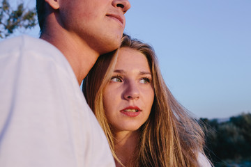 cropped image of a man embracing a young woman