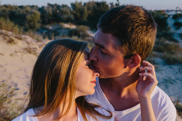 Fototapeta premium Young couple kissing outdoors