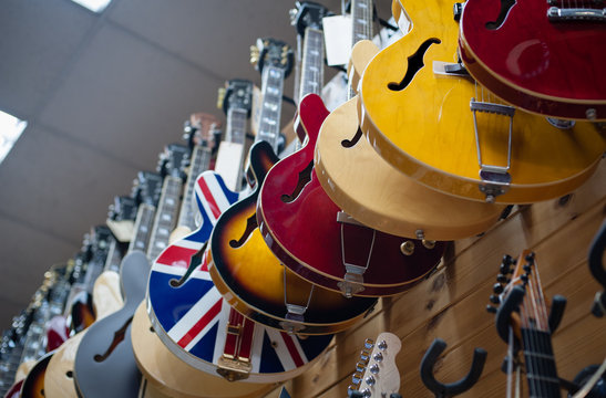 Many electric guitars body aligned in the store