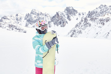 Fototapeta na wymiar Young woman with snowboard