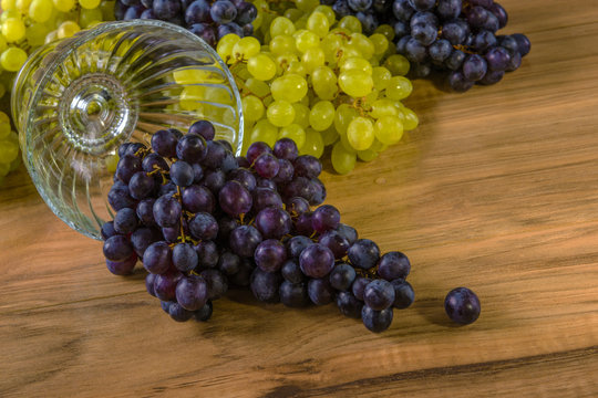 Fresh ripe grapes on a wooden table, rustic style