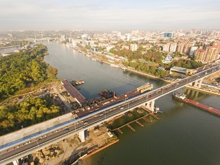 Obraz premium Construction of the bridge across the river. Aerial view.
