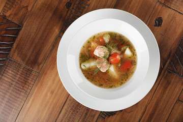 Chobra - traditional middle eastern soup in a white plate. Wooden background.