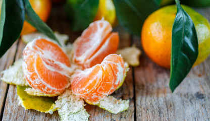  Mandarin.  Juicy ripe tangerines with leaves on the table. Sele