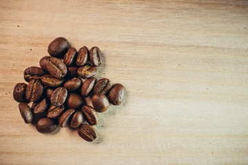 Coffee been with wooden spoon on wooden background