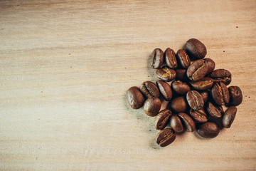 Coffee been with wooden spoon on wooden background