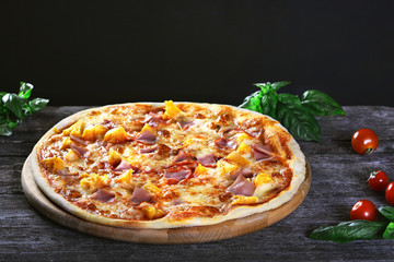 Pizza with pineapple , bacon and cheese mozzarella on the wooden