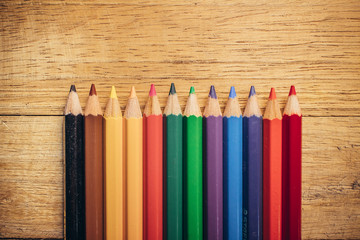 Crayons pencils on wooden background