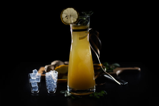 Selfmade Orange Ginger Lemonade in a carafe with two glasses