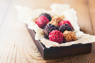Chocolate truffles. Rustic  wooden table. Holiday concept