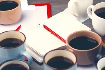 Many cups of coffee on wooden table. Team work concept