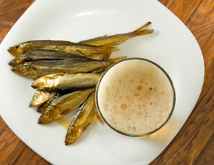  glass of beer and dried fish on a plate