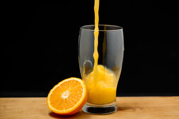 Pouring orange juice into glass. Copy space.
