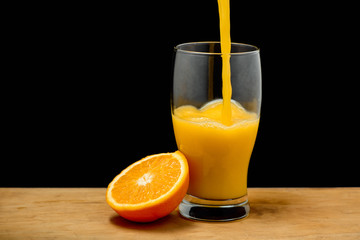 Pouring orange juice into glass. Copy space. 