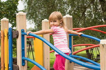 Sweet girl 3 year old playing in the playground
