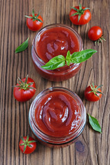 Tomato sauce and basil in glass jars