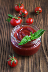Tomato sauce and basil in glass jar
