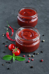 Tomato sauce and basil in glass jars