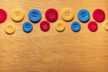 Crayon studs on wooden background,Sewing buttons, Plastic buttons, Colorful buttons background, Buttons close up, Buttons background