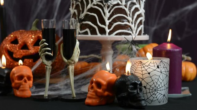 Spooky Halloween Party Table with chocolate spider cake and decorations, close up front focus static.