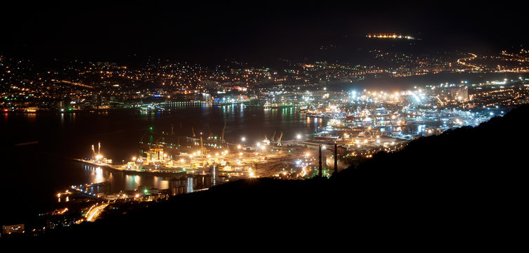 The bay of Novorossiysk by night with an illuminated port and city, Russia