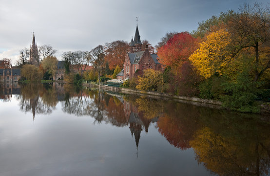 Reflections in a park in autumn in Bruges, Belgium