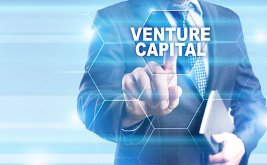 Businessman is pressing on the virtual screen and selecting "Venture capital".