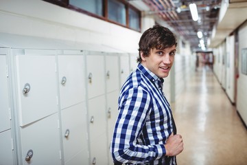 Portrait of student standing in locker room