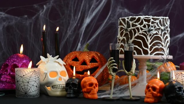 Spooky Halloween Party Table with chocolate spider cake and decorations, full table static.