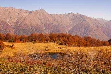 beautiful Caucasian mountains and lake in autumn season