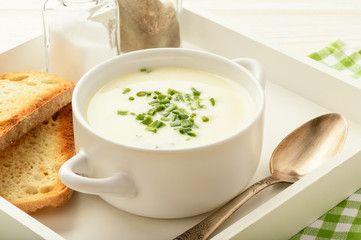Cheese cream soup on white wooden  tray.