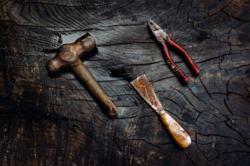 Set of manual tools on a dark wooden background.