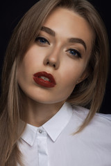 a large portrait of a beautiful young woman in the studio on a b